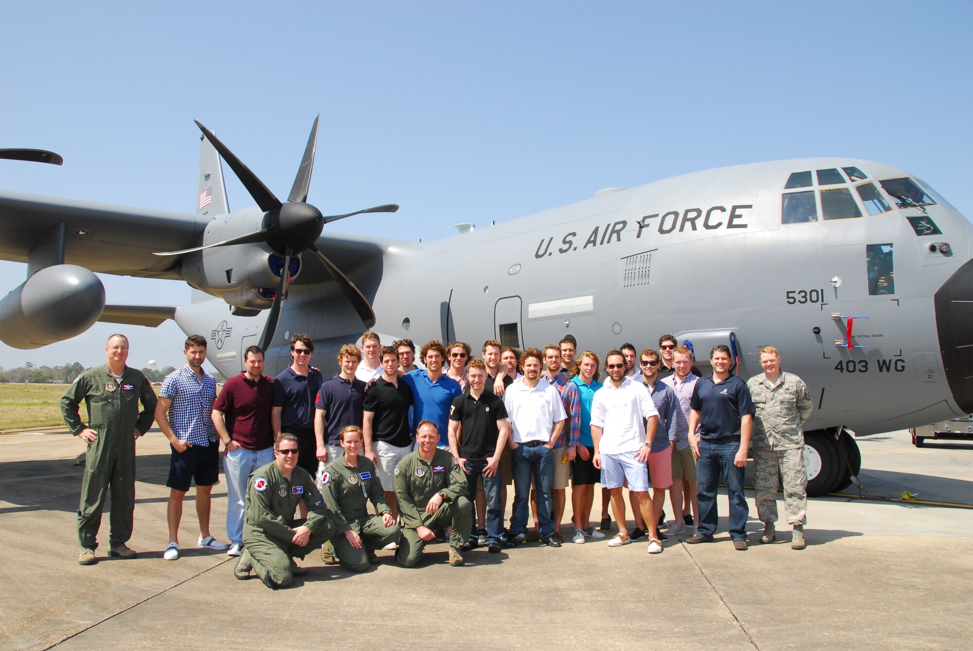 The Mississippi Surge Hockey team poses for a photo next to a WC-130J with Lt. Col. Douglas Fairtrace, MSgt Jeff Stack, Lt. Leesa Froelich, Lt. Col.  Shannon Hailes, members of the 53rd WRS, and MSgt Brian Lamar, 403rd Wing public affairs, during a tour at Keesler Air Force Base March 18, 2013.  The hockey team visited the 403rd Wing, taking in a static tour of a WC-130J, the aircraft maintenance shop and the propulsion shop.  (U.S. Air Force Photo by Tech. Sgt. Jessica L. Kendziorek)