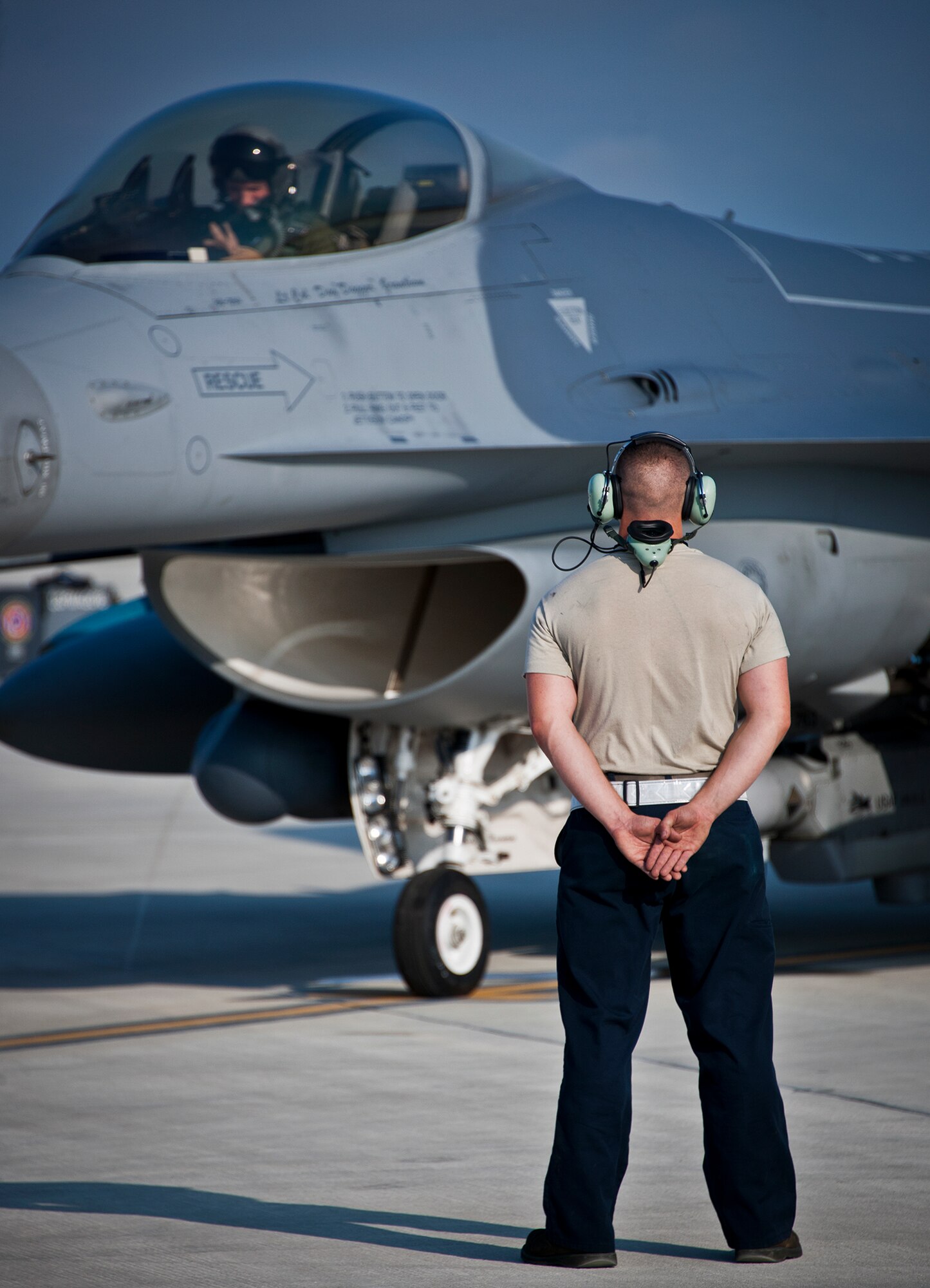 Senior Airman Johnathan Clark, a crew chief for the 482nd Fighter Wing, waits to marshal out his F-16 Fighting Falcon for a sortie at Eglin Air Force Base, Fla., March 18.  The 482nd F-16s traveled from Homestead ARB for the week-long, air-to-ground weapons system evaluation program called Combat Hammer.  Combat Hammer, run by the 86th Fighter Weapons Squadron, is used to evaluate the effectiveness and suitability of combat air force weapon systems. The air-to-air and air-to-ground WSEP evaluations are accomplished during tactical deliveries of fighter, bomber and unmanned aircraft system precision guided munitions, on realistic targets with air-to-air and surface-to-air defenses. (U.S. Air Force photo/Samuel King Jr.)