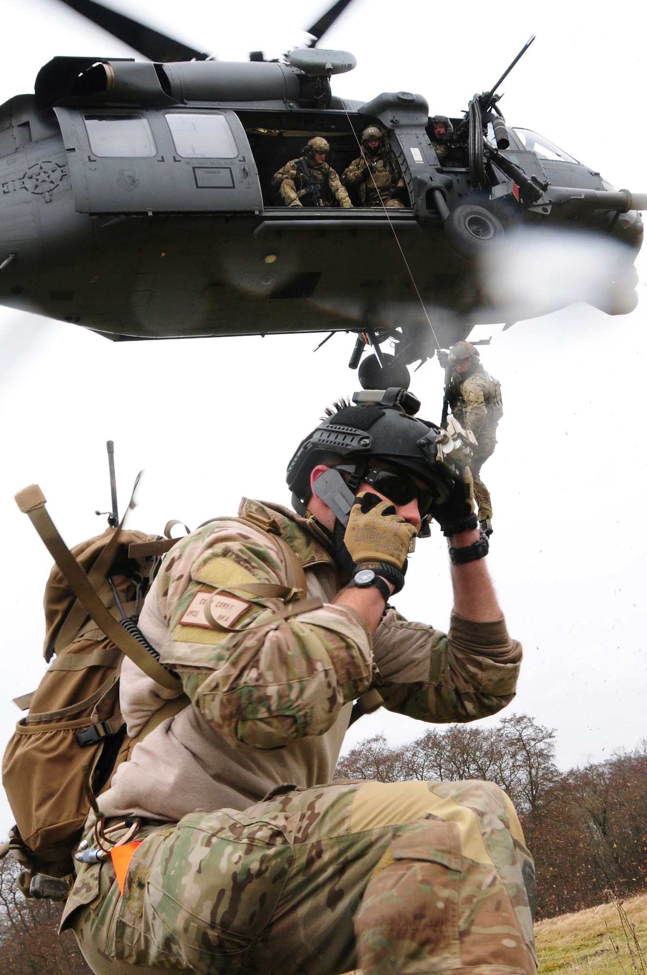STANTA TRAINING AREA, England -- Staff Sgt. Cody Cerny, 56th Rescue Squadron pararescueman, coordinates with an HH-60G Pave Hawk during War Week March 20, 2013. War Week is an annual training exercise testing the rescue squadron's capability to respond to emergency contingencies. (U.S. Air Force photo by Senior Airman Lausanne Morgan)