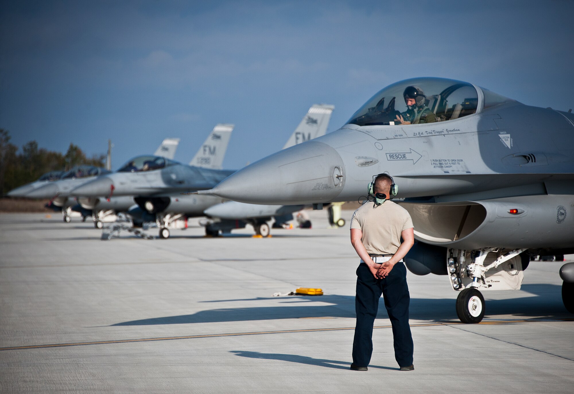 Senior Airman Johnathan Clark, a crew chief for the 482nd Fighter Wing, waits to marshal out his F-16 Fighting Falcon for a sortie at Eglin Air Force Base, Fla., March 18.  The 482nd F-16s traveled from Homestead ARB for the week-long, air-to-ground weapons system evaluation program called Combat Hammer.  Combat Hammer, run by the 86th Fighter Weapons Squadron, is used to evaluate the effectiveness and suitability of combat air force weapon systems. The air-to-air and air-to-ground WSEP evaluations are accomplished during tactical deliveries of fighter, bomber and unmanned aircraft system precision guided munitions, on realistic targets with air-to-air and surface-to-air defenses. (U.S. Air Force photo/Samuel King Jr.)
