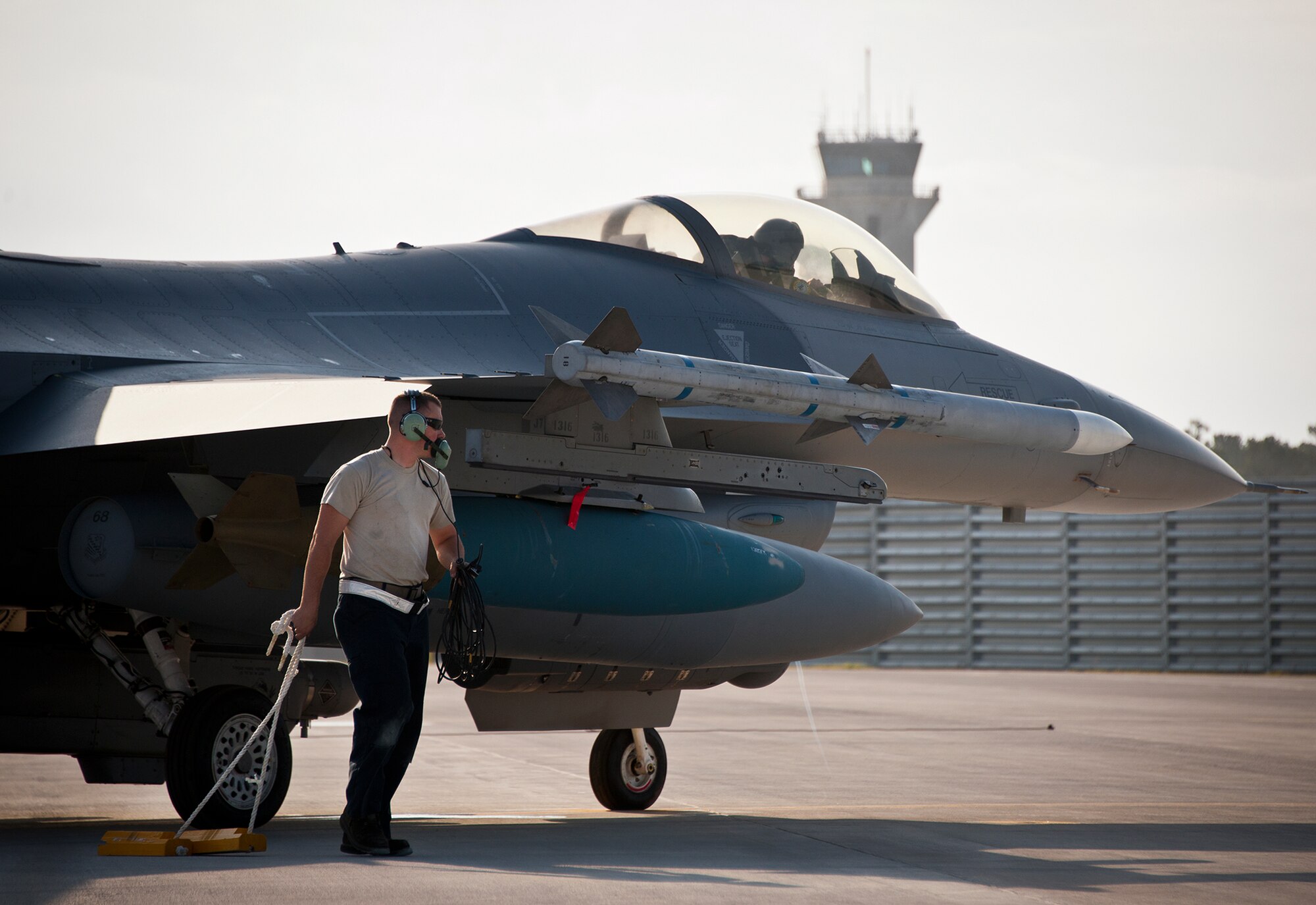 Senior Airman Johnathan Clark, a crew chief for the 482nd Fighter Wing, pulls the chocks away from an F-16 Fighting Falcon prior to a sortie at Eglin Air Force Base, Fla., March 18.  The 482nd F-16s traveled from Homestead ARB for the week-long, air-to-ground weapons system evaluation program called Combat Hammer.  Combat Hammer, run by the 86th Fighter Weapons Squadron, is used to evaluate the effectiveness and suitability of combat air force weapon systems. The air-to-air and air-to-ground WSEP evaluations are accomplished during tactical deliveries of fighter, bomber and unmanned aircraft system precision guided munitions, on realistic targets with air-to-air and surface-to-air defenses.  (U.S. Air Force photo/Samuel King Jr.)