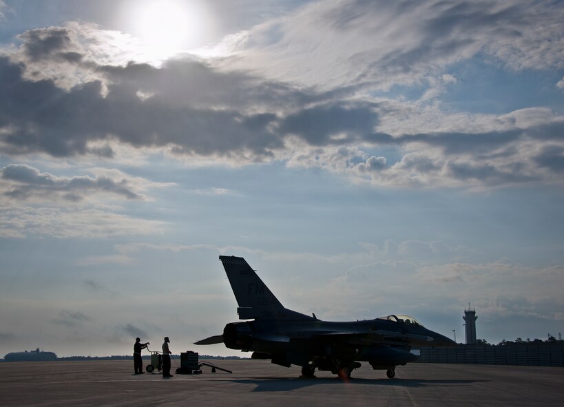 Maintainers with the 482nd Fighter Wing, perform preflight checks on an F-16 Fighting Falcon prior to a sortie at Eglin Air Force Base, Fla., March 18.  The 482nd F-16s traveled from Homestead ARB for the week-long, air-to-ground weapons system evaluation program called Combat Hammer.  Combat Hammer, run by the 86th Fighter Weapons Squadron, is used to evaluate the effectiveness and suitability of combat air force weapon systems. The air-to-air and air-to-ground WSEP evaluations are accomplished during tactical deliveries of fighter, bomber and unmanned aircraft system precision guided munitions, on realistic targets with air-to-air and surface-to-air defenses.  (U.S. Air Force photo/Samuel King Jr.)