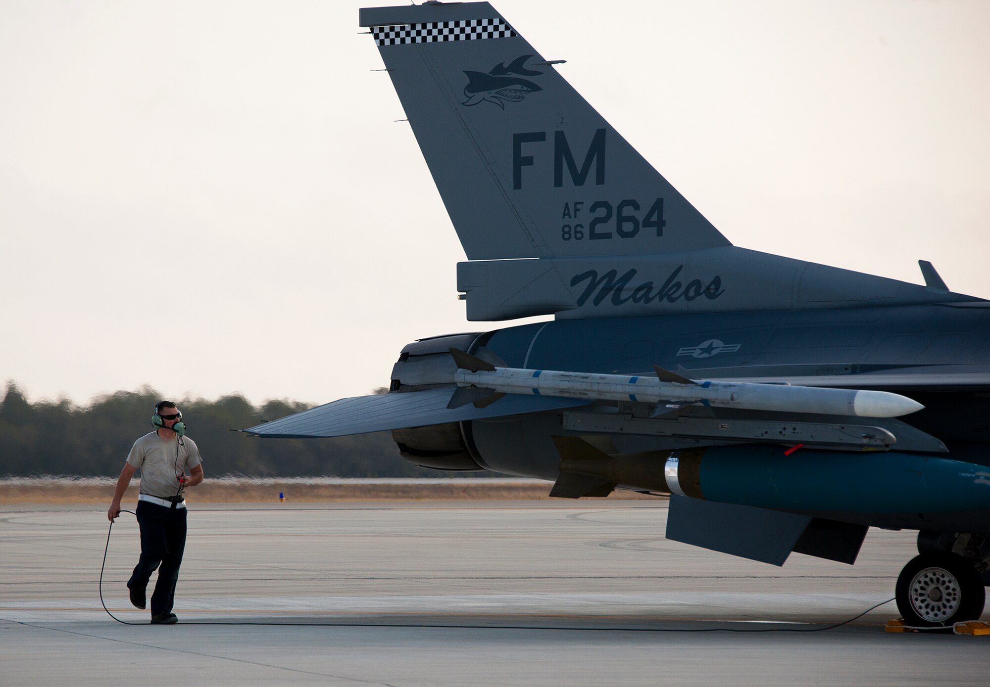 Senior Airman Johnathan Clark, a crew chief for the 482nd Fighter Wing, performs preflight checks on an F-16 Fighting Falcon prior to a sortie at Eglin Air Force Base, Fla., March 18.  The 482nd F-16s traveled from Homestead ARB for the week-long, air-to-ground weapons system evaluation program called Combat Hammer.  Combat Hammer, run by the 86th Fighter Weapons Squadron, is used to evaluate the effectiveness and suitability of combat air force weapon systems. The air-to-air and air-to-ground WSEP evaluations are accomplished during tactical deliveries of fighter, bomber and unmanned aircraft system precision guided munitions, on realistic targets with air-to-air and surface-to-air defenses.  (U.S. Air Force photo/Samuel King Jr.)