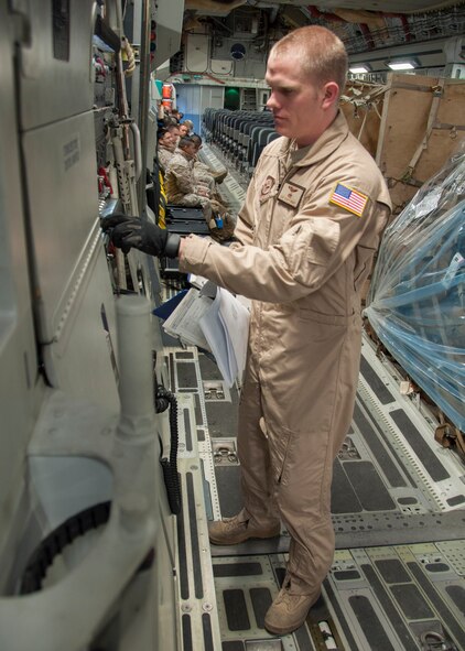Staff Sgt. Scott Reddy, 817th Expeditionary Airlift Squadron Detachment 1 loadmaster, completes pre-flight inspections in the back of a C-17 Globemaster III aircraft March 22, 2013, at Transit Center at Manas, Kyrgyzstan. In addition to conducting pre-flight inspections, loadmasters are responsible for ensuring the safety of passengers and cargo during flight. (U.S. Air Force photo/Tech. Sgt. Rachel Martinez)