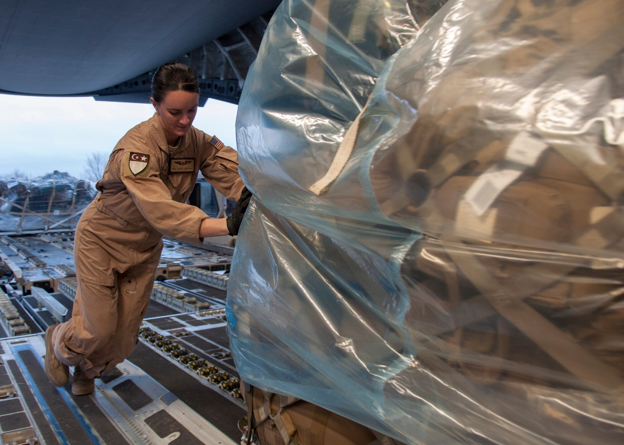 Senior Airman Casey Jackson, 817th Expeditionary Airlift Squadron Detachment 1 loadmaster, pushes a pallet of baggage onto a C-17 Globemaster III aircraft March 22, 2013, at Transit Center at Manas, Kyrgyzstan. Typical missions for the 817 EAS include passenger movements in and out of Afghanistan. (U.S. Air Force photo/Tech. Sgt. Rachel Martinez)