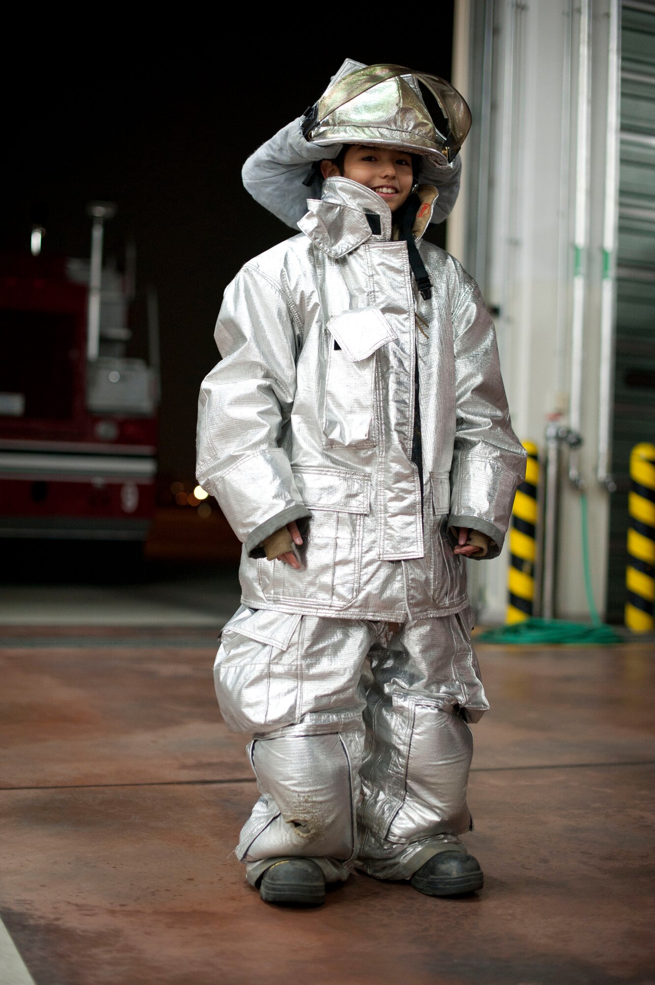 YOKOTA AIR BASE, Japan -- Andrew McFarren, Boy Scouts of America Troop 45, poses for a photo March 20, 2013, at Yokota Air Base, Japan. The scouts got to try on the equipment that Yokota's firefighters wear when they fight fires. (U.S. Air Force photo by Airman 1st Class Meagan Schutter)
