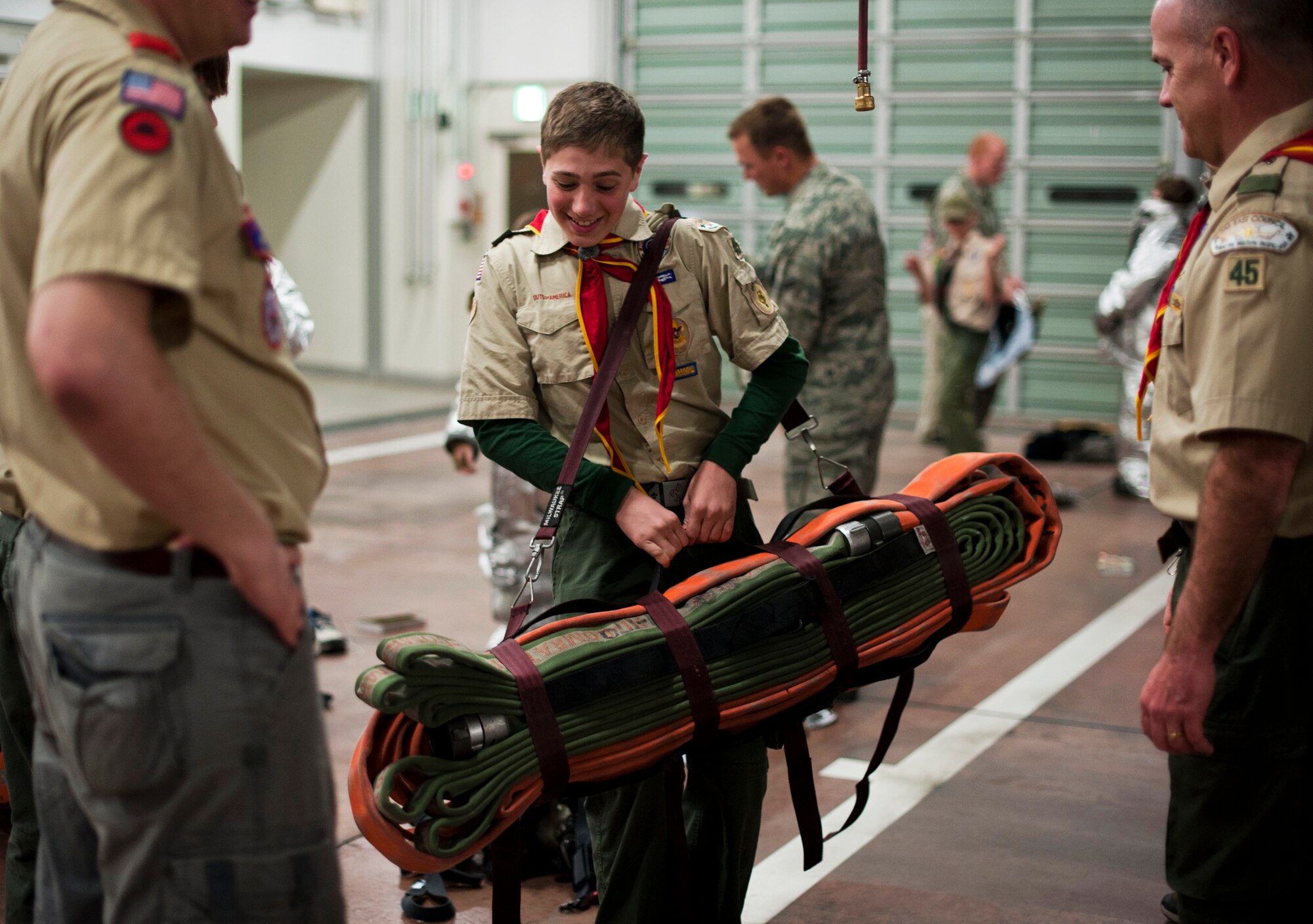 YOKOTA AIR BASE, Japan -- Ben Kindberg, Boy Scouts of America Troop 45, holds a water hose known as a Hotel Pack, March 20, 2013, at Yokota Air Base, Japan. The hose weighs 40 pounds and is 100 feet long when not bundled. (U.S. Air Force photo by Airman 1st Class Meagan Schutter)