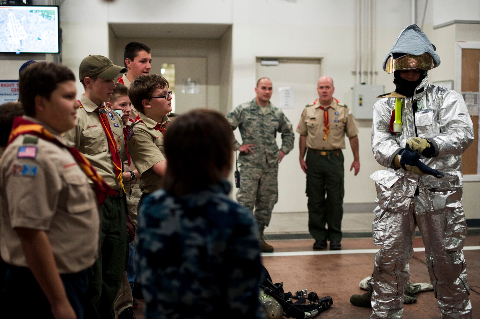 YOKOTA AIR BASE, Japan -- Airman 1st Class Andrew Hill, 374th Civil Engineer Squadron firefighter, demonstrates how to put on his turn-out gear March 20, 2013, at Yokota Air Base, Japan. Putting on gear quickly is crucial when responding to a fire emergency. (U.S. Air Force photo by Airman 1st Class Meagan Schutter)