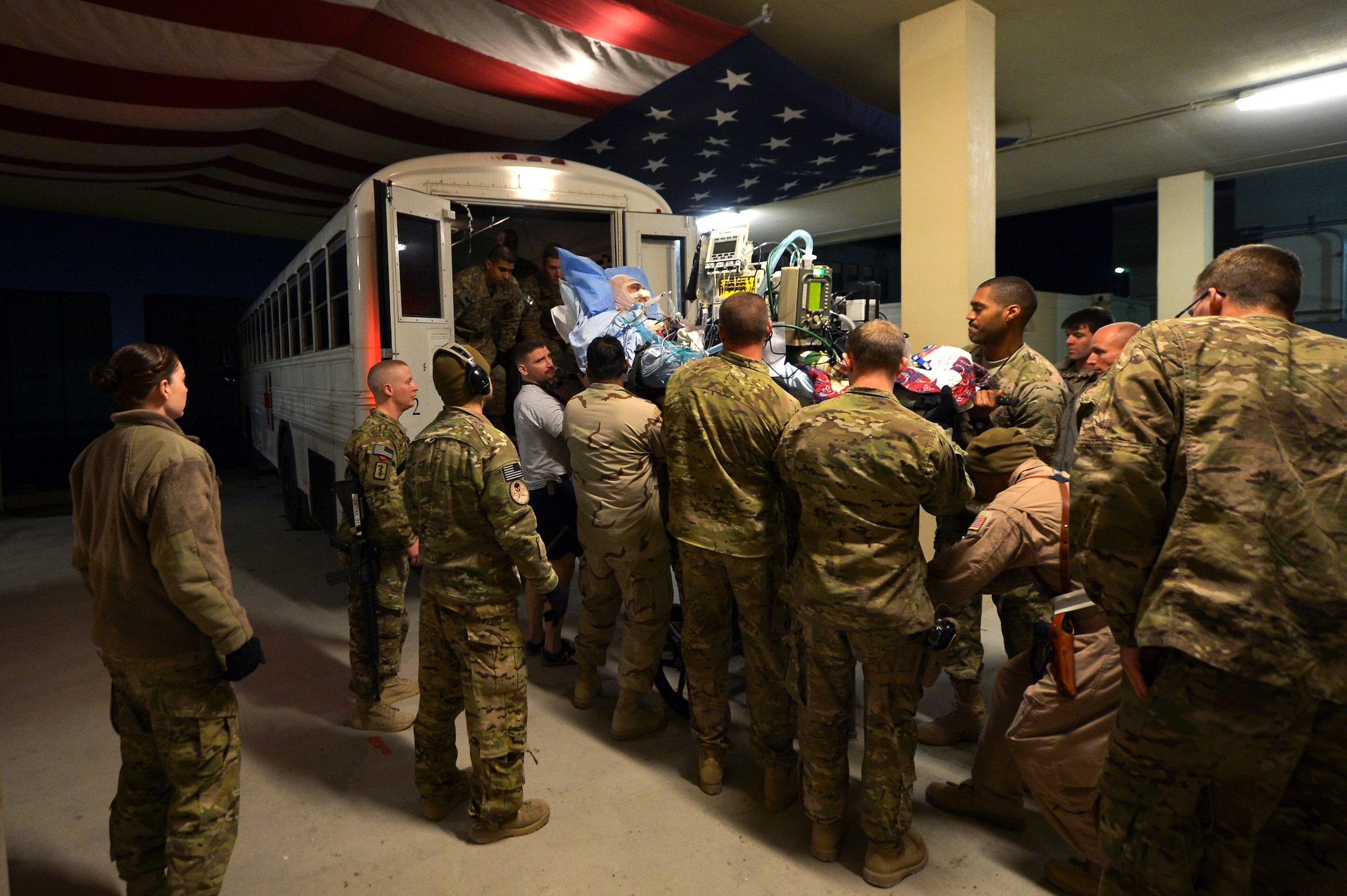 Members of the Contingency Aeromedical Staging Facility and 455th Expeditionary Aeromedical Evacuation Squadron assist patients onto medical bus bound for the flightline on Bagram Airfield, Afghanistan, March 21, 2013. The CASF is the relay between the Craig Joint Theater Hospital and aeromedical evacuation missions throughout Afghanistan.  (U.S. Air Force photo/Senior Airman Chris Willis)