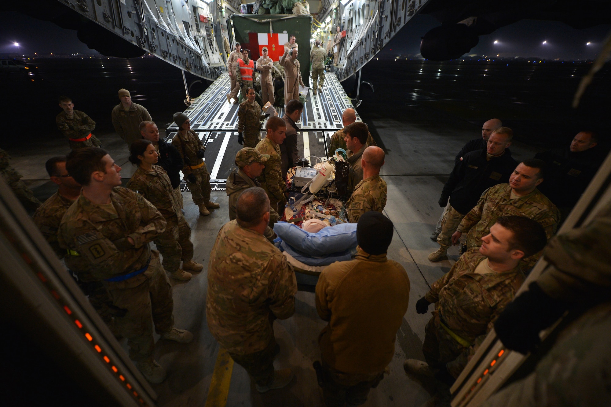Members of the Contingency Aeromedical Staging Facility and 455th Expeditionary Aeromedical Evacuation Squadron assist patients onto C-17 Globemaster III on Bagram Airfield, Afghanistan, March 21, 2013. The CASF is the relay between the Craig Joint Theater Hospital and aeromedical evacuation missions throughout Afghanistan.  (U.S. Air Force photo/Senior Airman Chris Willis)