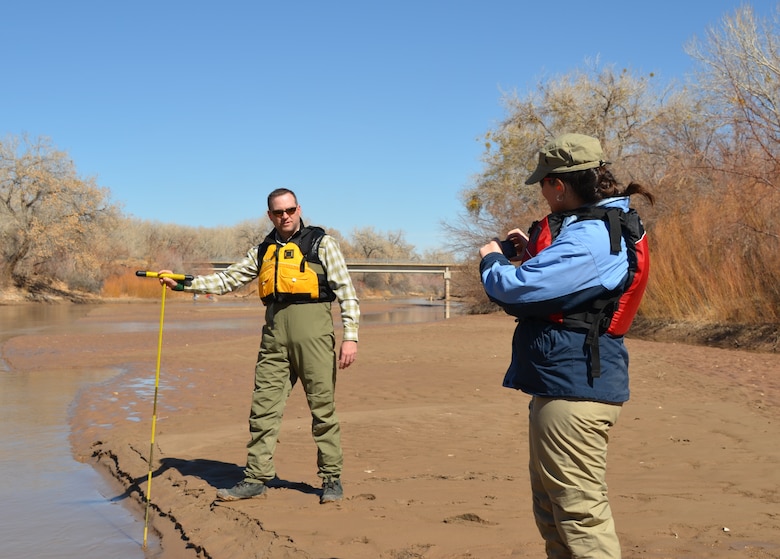 Socorro, N.M., -- Ryan Gronewold, Albuquerque District's Rio Grande coordinator, measures the water level in the Rio Grande with a calibrated survey rod. Amanda Green, a Department of the Army Intern in the District, records the data.