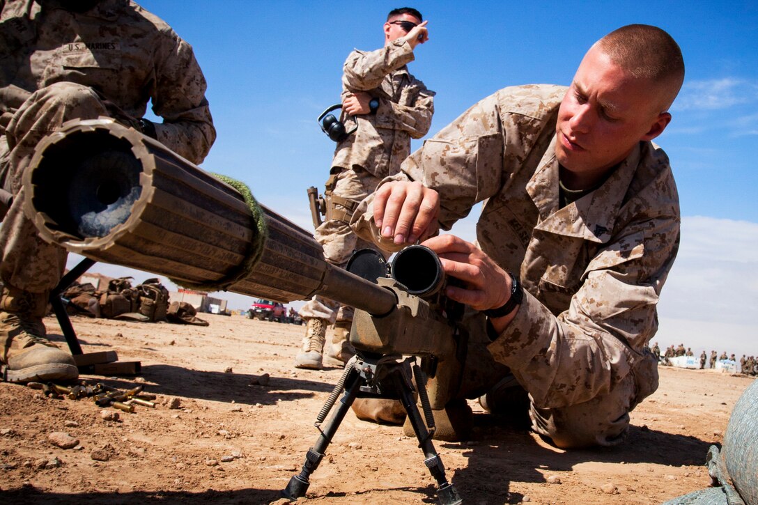 U.S. Marine Corps Cpl. Darek Kelsey, right, makes adjustments to an M40A5 sniper rifle at a live-fire range on Camp Leatherneck in Afghanistan's Helmand province, March 23, 2013. Kelsey, a scout sniper, is assigned to the 3rd Battalion, 4th Marine Regiment.