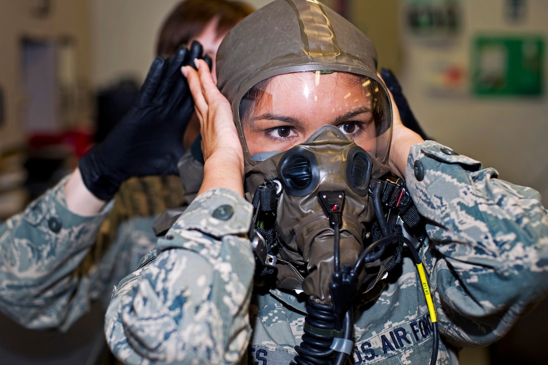 Air Force Senior Airman Audrey Jones, front, performs a function check ...