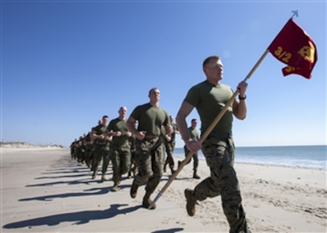 U. S. Marines from Battalion Landing Team 3/2 perform a motivational run on Onslow Beach, N.C., on March 4, 2013.  The Marines conducted the run to generate esprit de corps and enhance unit cohesion before embarking on their deployment this month.  The battalion landing team is the ground combat element of the 26th Marine Expeditionary Unit