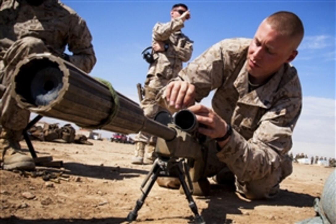 U.S. Marine Corps Cpl. Darek Kelsey, right, makes adjustments to an M40A5 sniper rifle at a live fire range on Camp Leatherneck, Helmand Province, Afghanistan, March 23, 2013. Kelsey calibrated his weapon before conducting combat operations in support of Operation Enduring Freedom. Kelsey is assigned to the 3rd Battalion, 4th Marine Regiment.