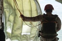 A Marine from Landing Support Company, Combat Logistics Regiment 27, 2nd Marine Logistics Group near Camp Lejeune, N.C., prepares for his first jump in the fleet March 20, 2013.  The red helmet he wears identifies him as a novice, or “cherry” jumper. 