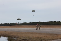 Marines from the Landing Support Company, Combat Logistics Regiment 27, 2nd Marine Logistics Group discuss the jump they just completed near Camp Lejeune, N.C., March 20, 2013. It was the Marine in the red helmet’s first jump since joining the fleet. 