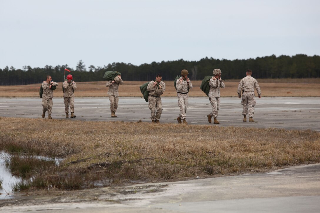 Marines from Landing Support Company, Combat Logistics Regiment 27, 2nd Marine Logistics Group follow their stick leader after completing a jump near Camp Lejeune, N.C., March 20, 2013.  Most of these Marines renewed their quarterly jump certification, and others jumped for the first time during this training evolution.