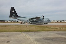 A Marine from Landing Support Company, Combat Logistics Regiment 27, 2nd Marine Logistics aboard Marine Corps Air Station New River, N.C., walks away from a C-130 Hercules before an airborne exercise March 20, 2013. The plane could not leave until all crew members attended a safety brief. 
