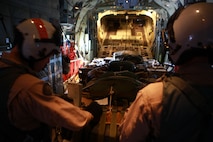 A C-130 aircrew reviews notes and prepares cargo during an airborne exercise near Camp Lejeune, N.C., March 20, 2013.  This exercise was coordinated with Landing Support Company, Combat Logistics Regiment 27, 2nd Marine Logistics Group.