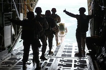 An assistant jump master gives Marines from Landing Support Company, Combat Logistics Regiment 27, 2nd Marine Logistics Group the “OK” to jump during an airborne exercise near Camp Lejeune, N.C.,  March 20, 2013. Marines jumped from a height of 1200 feet to meet their quarterly requirement. 
