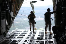 Marines from Landing Support Company, Combat Logistics Regiment 27, 2nd Marine Logistics Group leap from the back of a C-130 Hercules over a training field near Camp Lejeune, N.C., March 20, 2013. These Marines departed the aircraft without a hint of hesitation. 