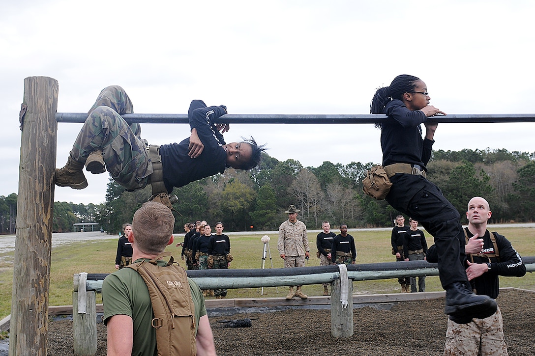 Marine Officer applicants attempt to climb over the first horizontal-bar of the obstacle course on Paige Field aboard Parris Island, S.C., March 23, 2013. The officer applicants are students recruited from colleges and universities from across the Southeastern U.S., including all of Louisiana, Mississippi, Georgia, South Carolina, Florida and Tennessee, to include parts of North Carolina. The candidates were brought to Marine Corps Recruit Depot Parris Island for this annual two-day training exercise where they were exposed to various parts of officer training in order to gain a better understanding of what will be expected of them when they attend Officer Candidate School at Marine Corps Base Quantico, Va. (U.S. Marine Corps photo by Pfc. John-Paul Imbody)