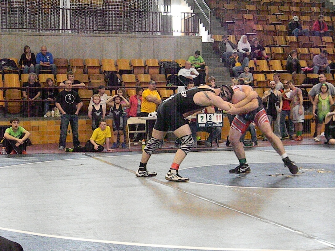 Sgt. Jared A. Parker (Left) locks up with his opponent during the Missouri Winter Games. Parker went on to take the gold in his weight class.