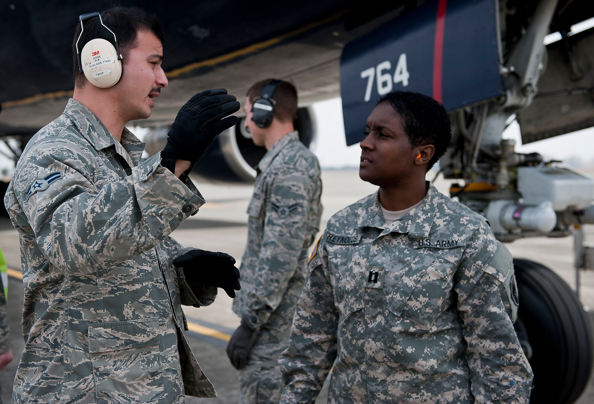 YOKOTA AIR BASE, Japan -- Airman 1st Class Grayson Glass speaks with Capt. Sasha Reynolds from the 623rd Movement Control Team, 35th Combat Sustainment Support Battalion, about his job and how it plays into the mission at Yokota Air Base, Japan,March 20, 2013. Members of the 623rd MCT deal with the loading and unloading of cargo everyday in their career field, and their visit to Yokota allowed them to familiarize themselves with possible Air Force assets they will encounter while moving cargo in a deployed location. (U.S. Air Force photo by Airman 1st Class Meagan Schutter)