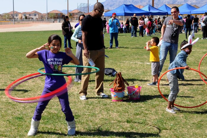 Michelle Henao, daughter of Staff Sgt. Juan Henao, 99th Medical Support Squadron, hula hoops during the Easter egg hunt and extravaganza March 23, 2013, at the Nellis Youth Center sports field on Nellis Air Force Base, Nev. The event included Easter egg hunts, games, and a jumpy house. (U.S. Air Force photo by Tech. Sgt. Taylor Worley)