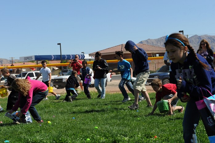 Children run onto the Nellis Youth Center sports field at the beginning of the 9 to 12 year old Easter egg hunt during the Easter egg hunt and extravaganza March 23, 2013, at Nellis Air Force Base, Nev. The event provided free egg hunts, games, and prizes for Nellis families. (U.S. Air Force photo by Tech. Sgt. Taylor Worley)
