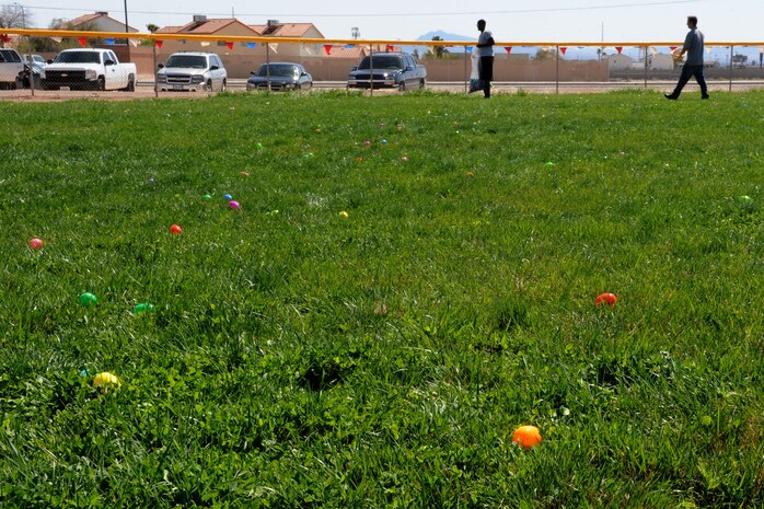 Volunteers cover the grass with plastic Easter eggs for an Easter egg hunt and extravaganza held at the Nellis Youth Center sports field March 23, 2013, at Nellis Air Force Base, Nev. The day was filled with multiple egg hunts, visits from the Easter bunny, games and prizes. (U.S. Air Force photo by Tech. Sgt. Taylor Worley)