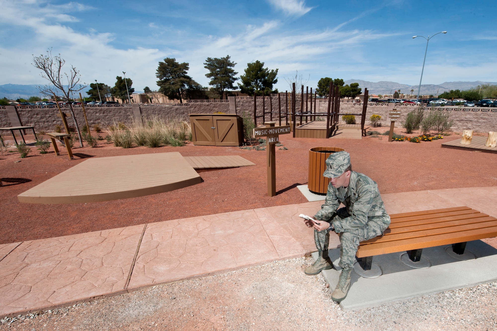 Chaplain (1st Lt.) Ammon Larson, 99th Air Base Wing Chapel, reads a Bible in the reflection garden located behind the chapel March 25, 2013, at Nellis Air Force Base, Nev. The reflection garden is open for people to use and includes a play area for children. (U.S. Air Force photo by Airman 1st Class Jason Couillard)