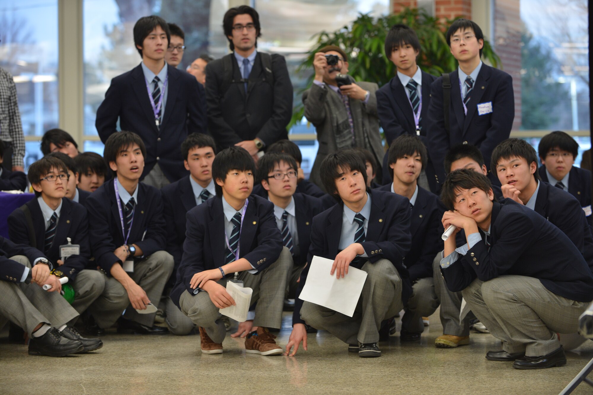 25 Japanese students from Sendai, Japan take a photo of the Japanese flag and Colorado state flag March 22, 2013, at Littleton High School, Littleton, Colo. The students from Japan came to convey a message of appreciation to military service members and others who extended assistance to Japan after the tsunami and earthquake devastation. (U.S. Air Force photo by Senior Airman Paul Labbe/Released)