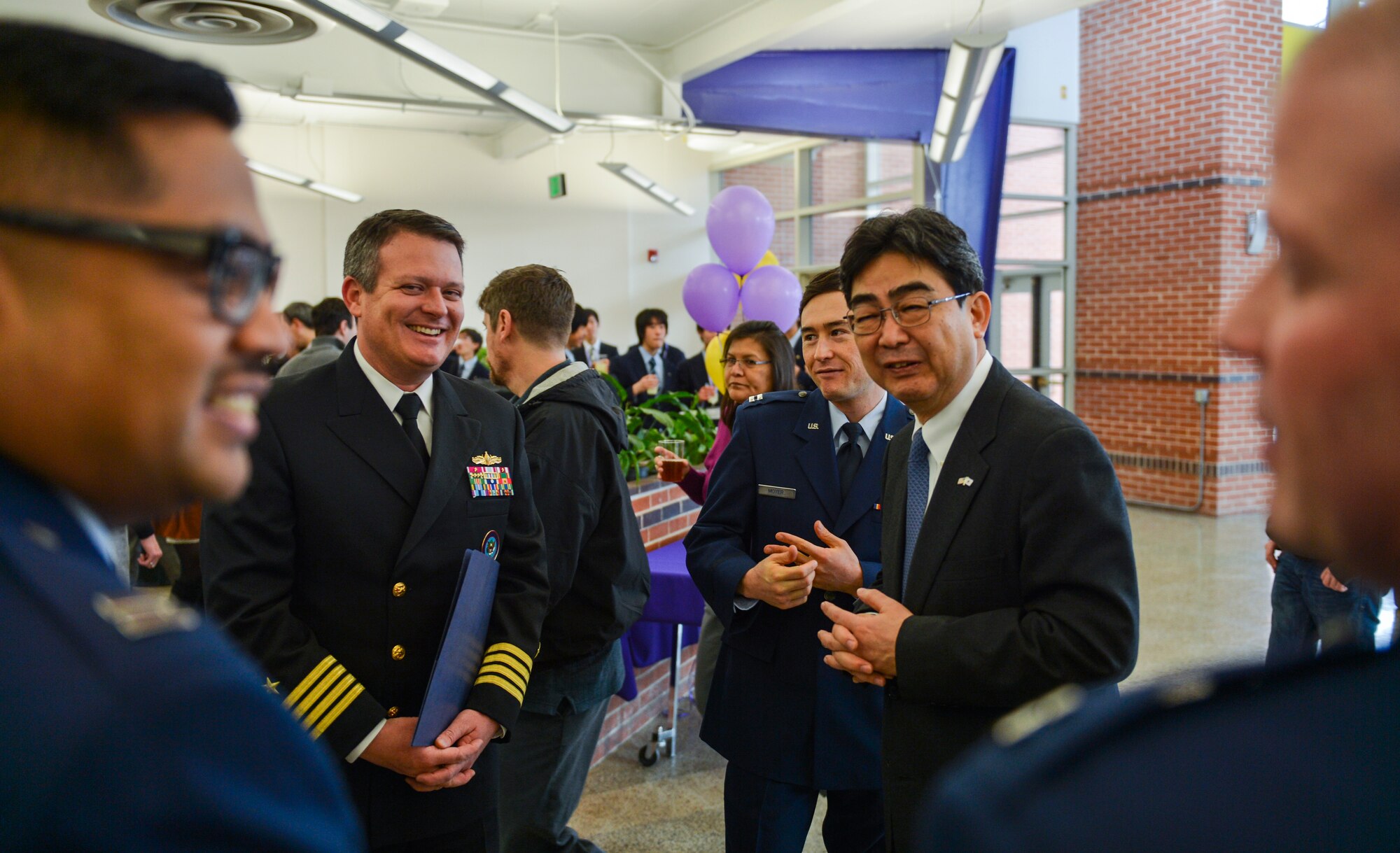 Ikuhiko Ono, Consul General of Japan, speaks with U.S. Navy Capt. Jeff Davis, U.S. Northern Command, and U.S. Air Force members from Schriever Air Force Base, Colorado Springs, during a Kizuna Project event March 22, 2013, at Littleton High School, Littleton, Colo. (U.S. Air Force photo by Senior Airman Paul Labbe/Released) 