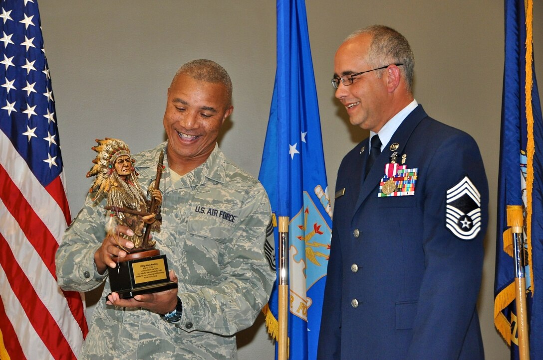 Chief Master Sgt. George Vaughn presents a farewell gift to Chief Master Sgt. Adam Reading upon his retirement  from the Air Force Reserve on March 9, 2012.  During his military career, Reading previously served in the Navy, Army and the Air National Guard.  Reading was superintendent for the 932nd Medical Squadron.  (U.S. Air Force photo/Tech. Sgt. Dan Oliver)