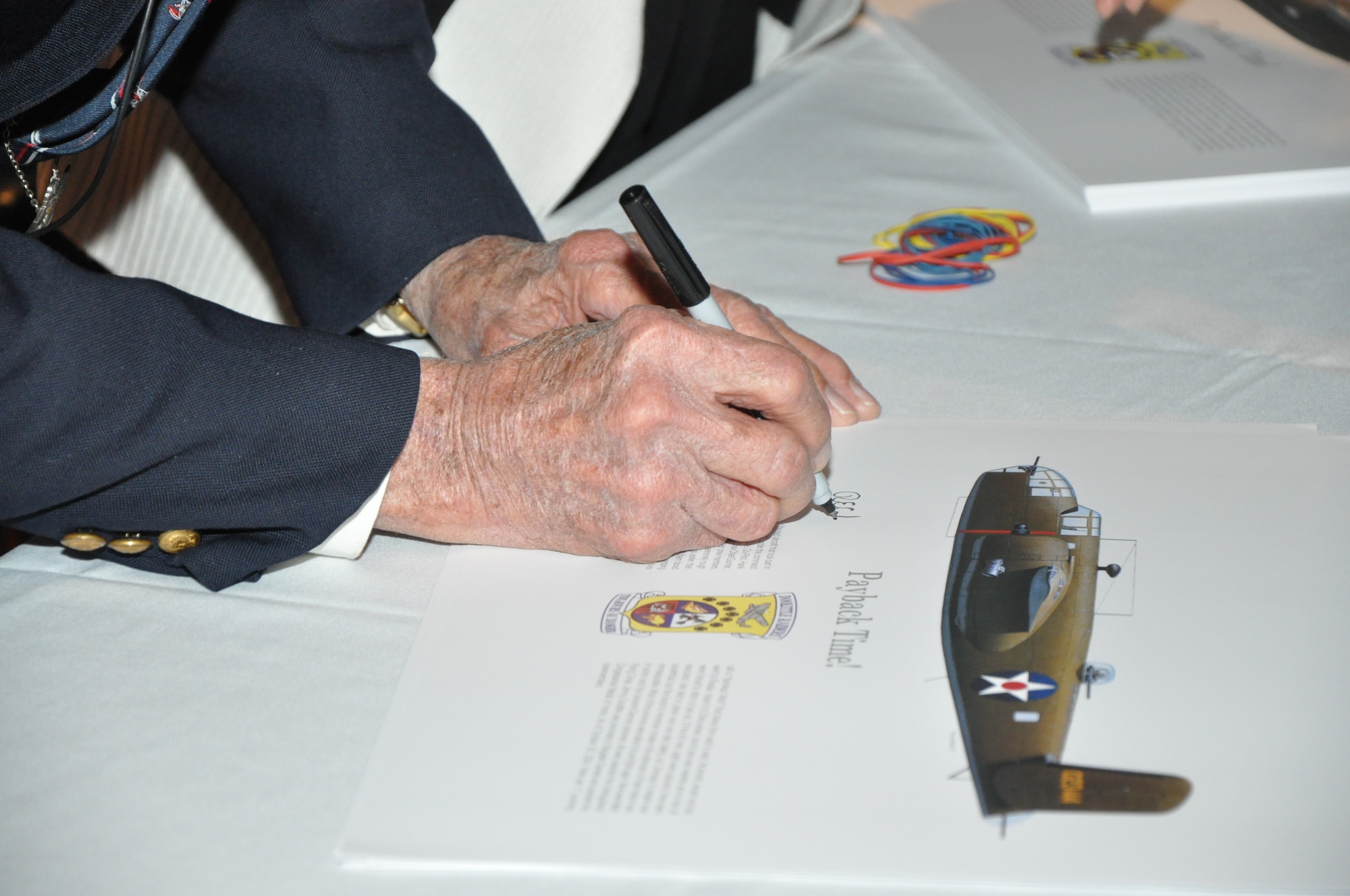 GOODFELLOW AIR FORCE BASE, Texas—U.S. Army Air Force retired Lt Col. Richard Cole signs autographs at the base theater after a question and answer session with community guests and team Goodfellow members, March 26. Cole is one of four remaining Doolittle Raiders. (U.S. Air Force photo/ 1st Lt. Leanne Hedgepeth) 