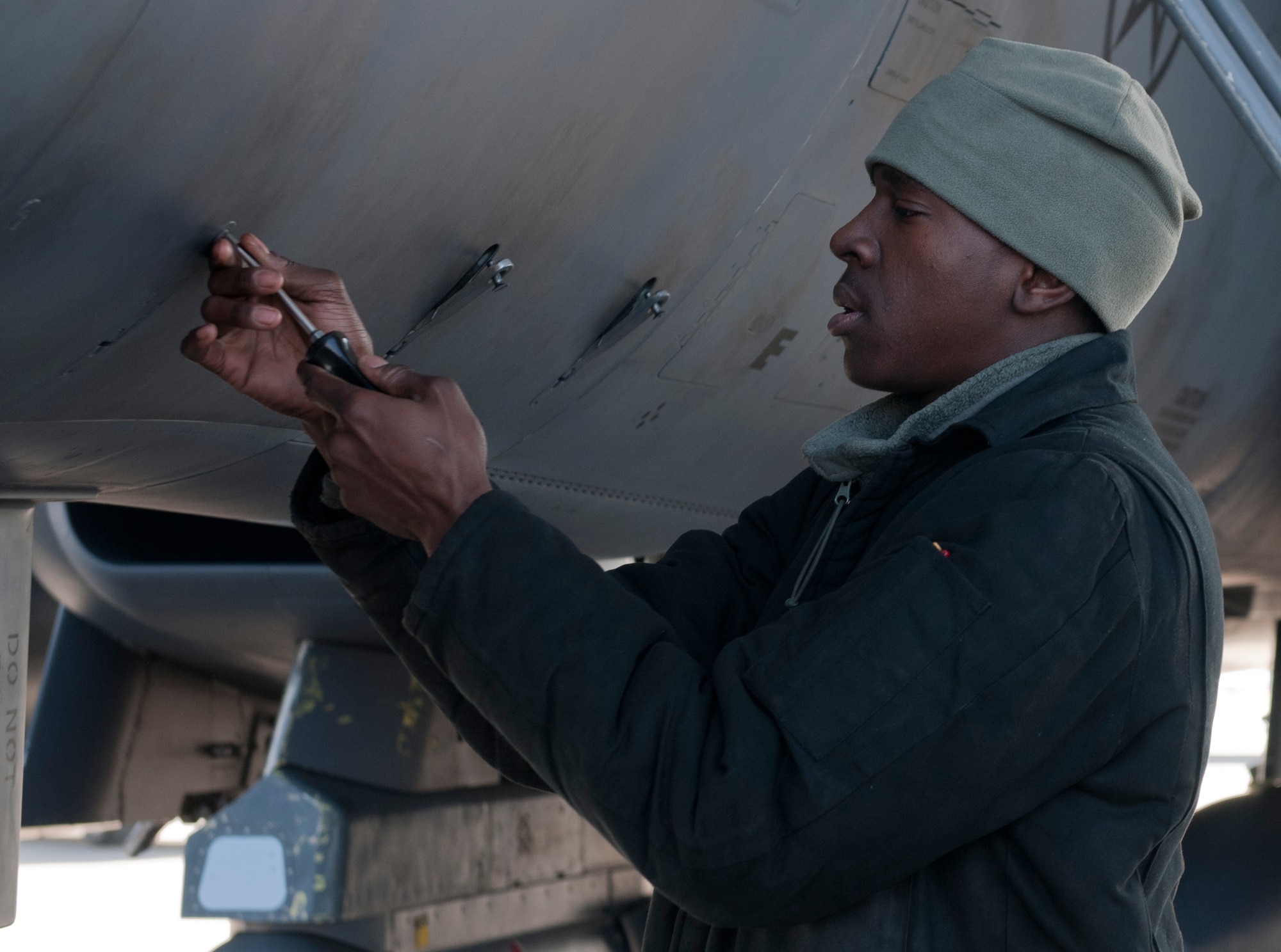 U.S. Air Force Airman 1st Class Emmanuel Osagiede, 389th Aircraft Maintenance Unit crew chief, tightens screws on an F-15E Strike Eagle during a pre-flight check, Feb. 28, 2013, at Mountain Home Air Force Base, Idaho. Maintenance crews must be meticulous when working on an aircraft to ensure the safety of the aircrew. (U.S. Air Force photo/Senior Airman Heather Hayward)