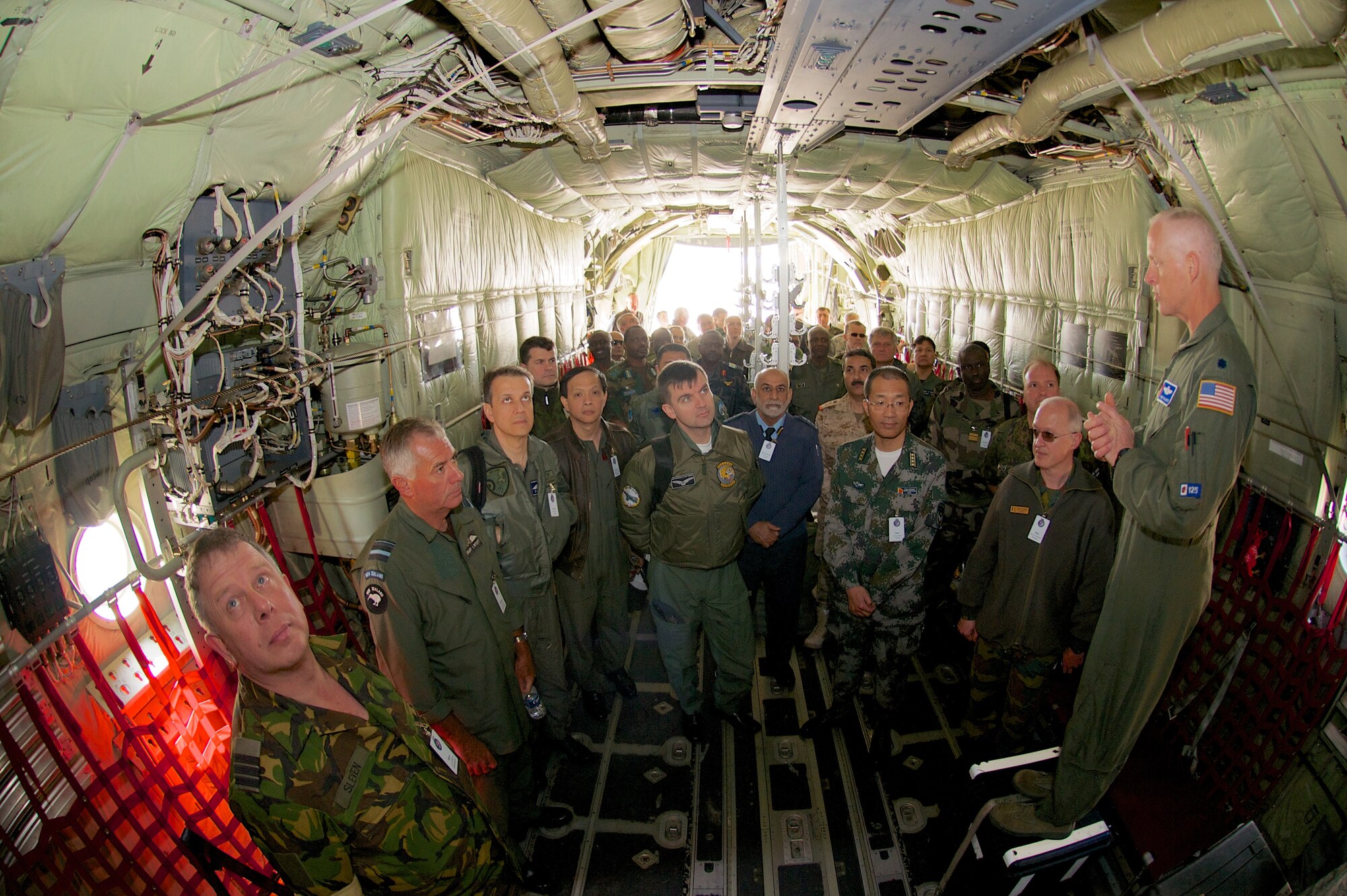 Lt. Col. Jon Talbot, Chief Meteorologist, 53rd Weather Reconnaissance Squadron, briefed members of the Air Attach?? on the variety of unique configurations of the Weather C-130J that are vital to retrieving data from inside storms. The group traveled from Washington, D.C., March 26, to visit a selection of active duty and reserve facilities at Keesler Air Force Base, Miss. (US Air Force Photo by Capt. J. Justin Pearce)