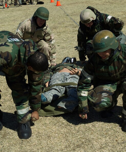 Dyess Airmen perform self-aid and buddy care March 26, 2013, at Dyess Air Force Base, Texas. Airmen across the 7th Bomb Wing simulated many scenarios that consisted of self-aid and buddy care and chemical, biological, radioactive, nuclear explosive responses in preparation for the wing’s upcoming operational readiness exercise. (U.S. Air Force photo by Airman 1st Class Kylsee Wisseman/ Released) 