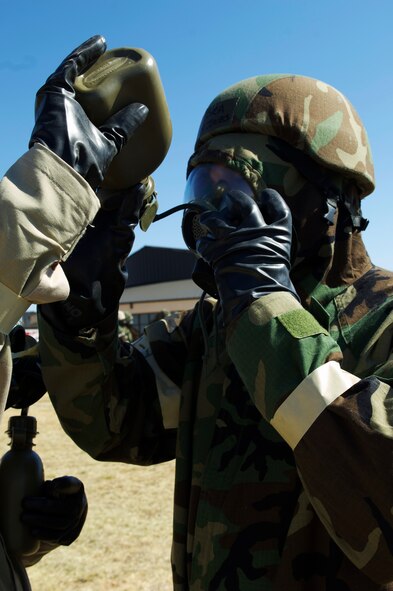 Senior Airman Bryan Jones, 7th Operations Support Squadron, drinks from his canteen while dressed in mission oriented protective posture equipment March 26, 2013, at Dyess Air Force Base, Texas. Airmen across the 7th Bomb Wing simulated many scenarios that consisted of self-aid and buddy care and chemical, biological, radioactive, nuclear explosive responses in preparation for the wing’s upcoming operational readiness exercise. (U.S. Air Force photo by Airman 1st Class Kylsee Wisseman/ Released)