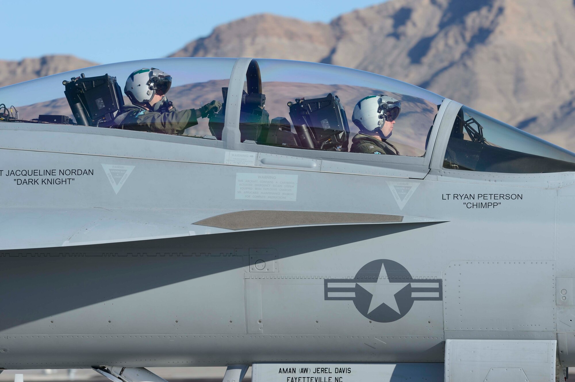 From left, U.S. Air Force Capt. Cole Davenport, 390th Electronic Combat Squadron logistics assistant director of operations and U.S. Navy Lt. John Reichel, VAQ-135 division officer, taxi down the runway after another exercise sortie March 11, 2013, at Nellis Air Force Base, Nev. During Red Flag 13-3 Airmen participated in aerial exercises that included more than 90 aircraft flying simultaneously. (Courtesy photo) 