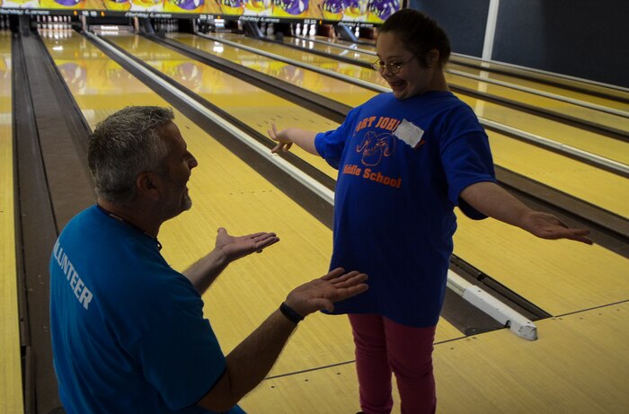 John Downey, spouse of Master Sgt. Dawn Downey, 628th Medical Group, congratulates a Special Olympian during the Special Olympics South Carolina Area 6 Bowling Event March 22, 2013, event in West Ashley, S.C. More than 15 Airmen and civilians from Joint Base Charleston volunteered to assist 35 middle school students. The children were from Zucker Middle School, Morningside Middle School, Fort Johnson Middle School and St. Andrews Middle School. (U.S. Air Force Photo/Airman 1st Class Jared Trimarchi) 