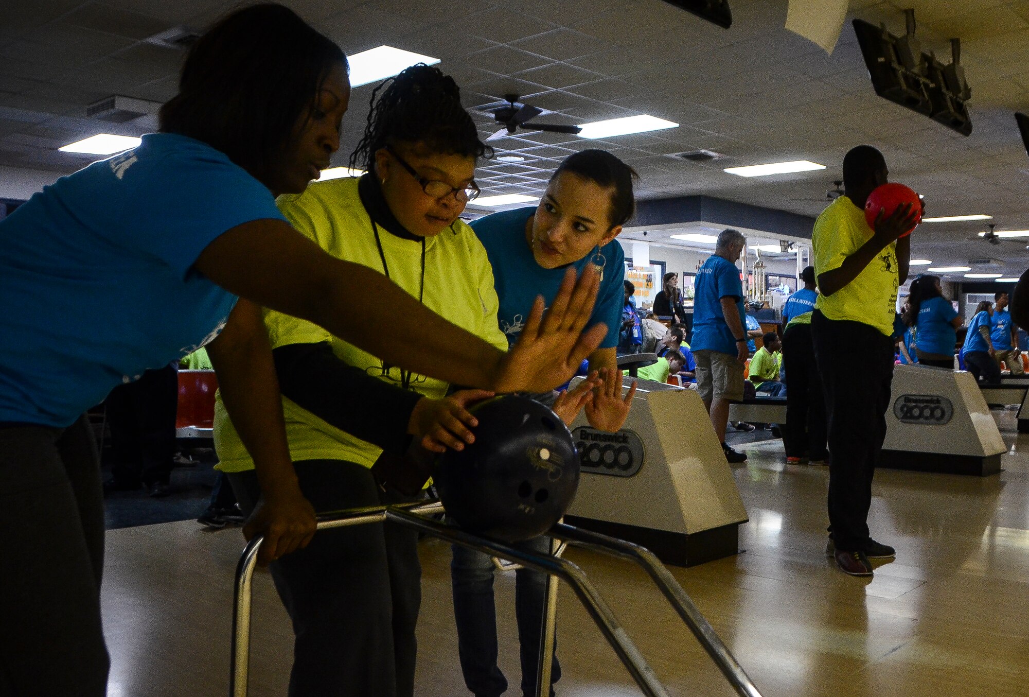 Staff Sgt. Ashley Johnson (left), 437th Aircraft Maintenance Squadron communication, navigation and mission systems specialist, instructs a Special Olympian bowl during the Special Olympics South Carolina Area 6 Bowling Event March 22, 2013, in West Ashley, S.C. More than 15 Airmen and civilians from Joint Base Charleston volunteered to assist 35 middle school students.  The children were from Zucker Middle School, Morningside Middle School, Fort Johnson Middle School and St. Andrews Middle School. (U.S. Air Force Photo/Airman 1st Class Jared Trimarchi) 