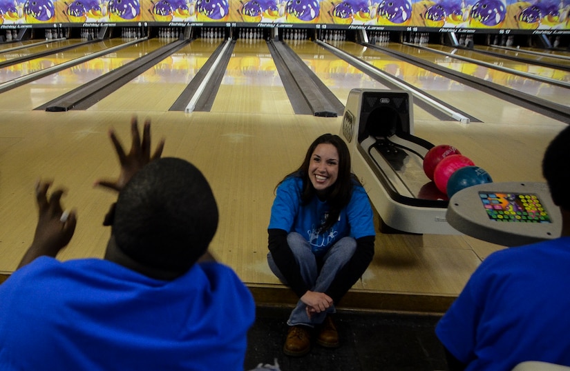Tech. Sgt. Jessica Meyer, 628th Medical Group Family Advocacy noncommissioned officer in charge, listens to a Special Olympian explain how he knocked the pins down during the Special Olympics South Carolina Area 6 Bowling Event March 22, 2013, in West Ashley, S.C. More than 15 Airmen and civilians from Joint Base Charleston volunteered to assist 35 middle school students. The children were from Zucker Middle School, Morningside Middle School, Fort Johnson Middle School and St. Andrews Middle School. (U.S. Air Force Photo/Airman 1st Class Jared Trimarchi) 