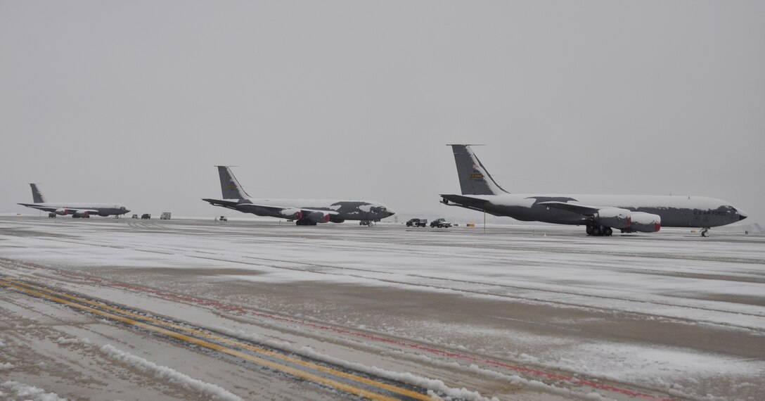 Three KC-135 Stratotankers from the 459th Air Refueling Wing sit on a snow-covered flightline on Joint Base Andrews, Md., after a snowstorm, March 25, 2012. The spring snowstorm was forecasted to bring up to five inches of snow to the local area.(U.S. Air Force photo/ Staff Sgt. Katie Spencer)