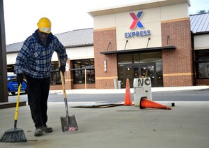 Keith Morange, construction site worker, cleans debris March 26, 2013 at the soon to open Express at Joint Base Andrews, Md. The official opening date is still to be determined however, progress is well on its way. (U.S. Air Force photo/Airman 1st Class Erin O’Shea) 
