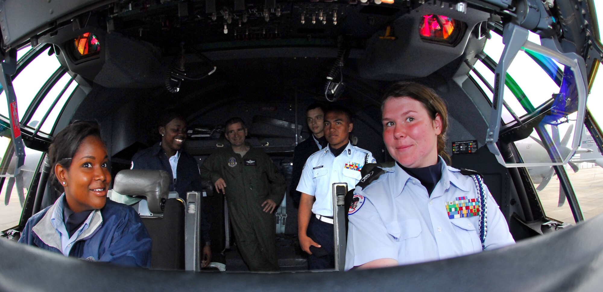 Lt. Col. Jeffrey Ragusa, 403rd Wing Chief of Safety and Hurricane Hunter pilot, gives members of the Biloxi High School Junior ROTC a tour of a WC-130J cockpit on March 22, 2013.  The JROTC toured Keesler AFB during an annual visit (U.S. Air Force Photo by TSgt Jessica L. Kendziorek).    