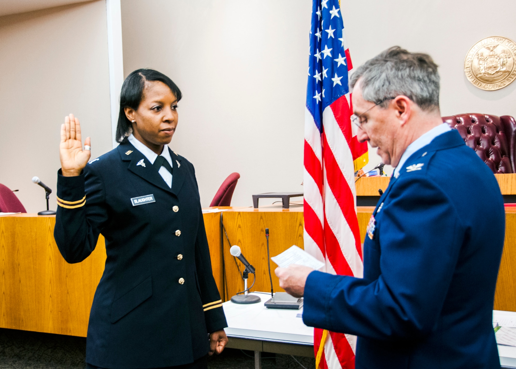 1st Lt. Nikki Slaughter, 328th Medical Detachment, U.S. Army Reserve, receives the oath of commissioned officers from retired Col. James Germain, U.S. Air Force Reserve, in a private ceremony at the Buffalo City Courthouse, Buffalo, N.Y. March 19, 2013.  Lt. Slaughter is an Army Reserve social worker and in her civilian career works as the 914th Airlift Wing’s Sexual Assault Response Coordinator and Behavioral Health Support Coordinator at the Niagara Falls Air Reserve Station, N.Y.  (U.S. Air Force photo by Tech. Sgt. Joseph McKee).