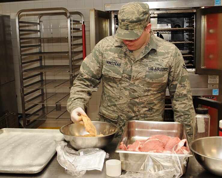 Airman 1st Class Donald Winstead, 2nd Force Support Squadron food service specialist, prepares pork chops at the Red River Dining Facility on Barksdale Air Force Base, La., March 26. The DFAC strives to offer a balanced diet of fresh, in-season fruits and vegetables and top quality cuts of meat. (U.S. Air Force photo/Senior Airman Sean Martin)